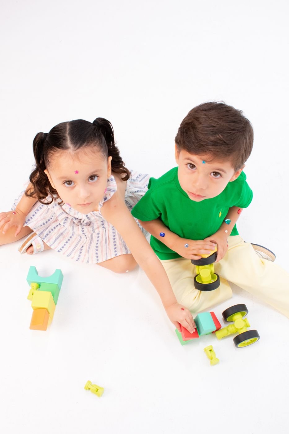 Toddlers exploring colorful sensory toys